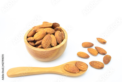 Almonds in brown wooden bowl,isolated on white background 