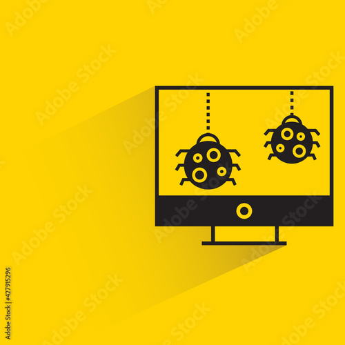 bug malware on desktop computer with shadow on yellow background