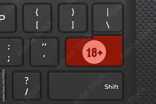 18+ icon on keyboard key. Conceptual idea of legal age, under 18