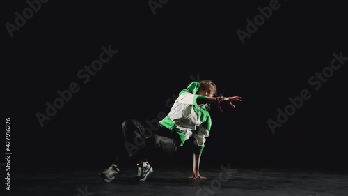 B-Girl dancing break dance on a black background photo