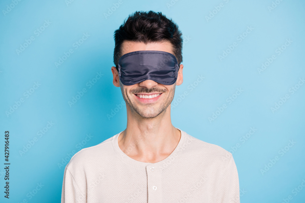 Portrait of nice attractive cheerful brunet guy wearing sleep mask good nap isolated over bright blue color background Portrait of nice attractive cheerful brunet guy wearing sleep mask good nap isolated over bright blue color background