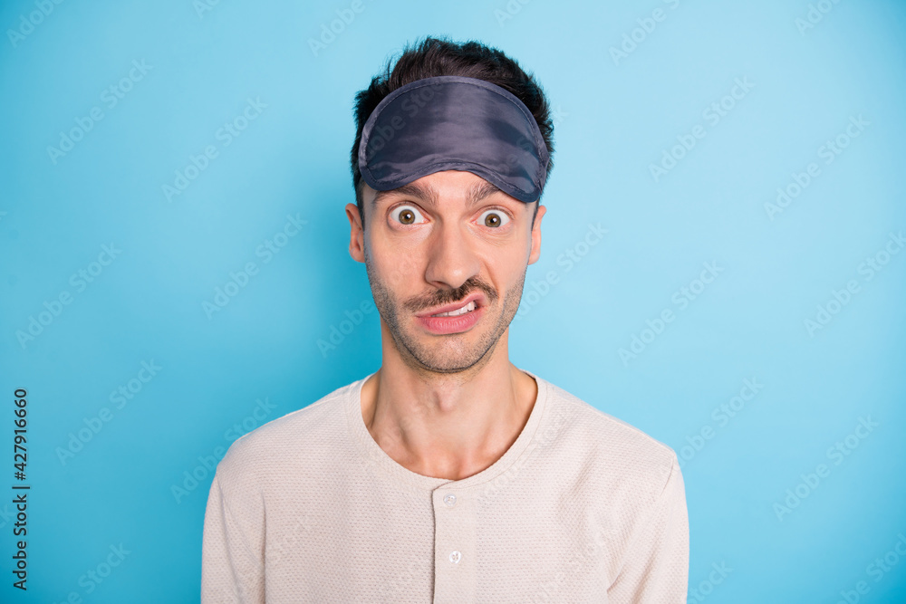 Portrait of nice puzzled brunet guy wearing sleep mask cant asleep dislike isolated over bright blue color background Portrait of nice puzzled brunet guy wearing sleep mask cant asleep dislike isolated over bright blue color background