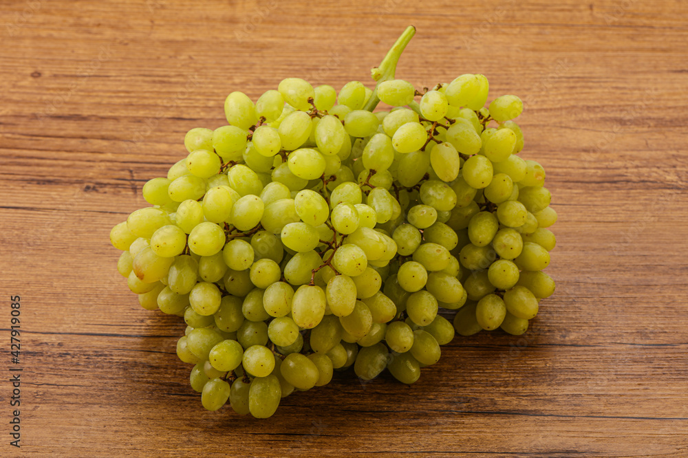 Green grape branch over background Green grape branch over background