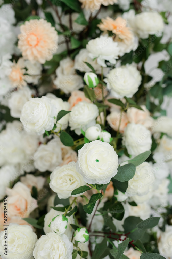 close-up of artificial flowers of white and pink color in the room.