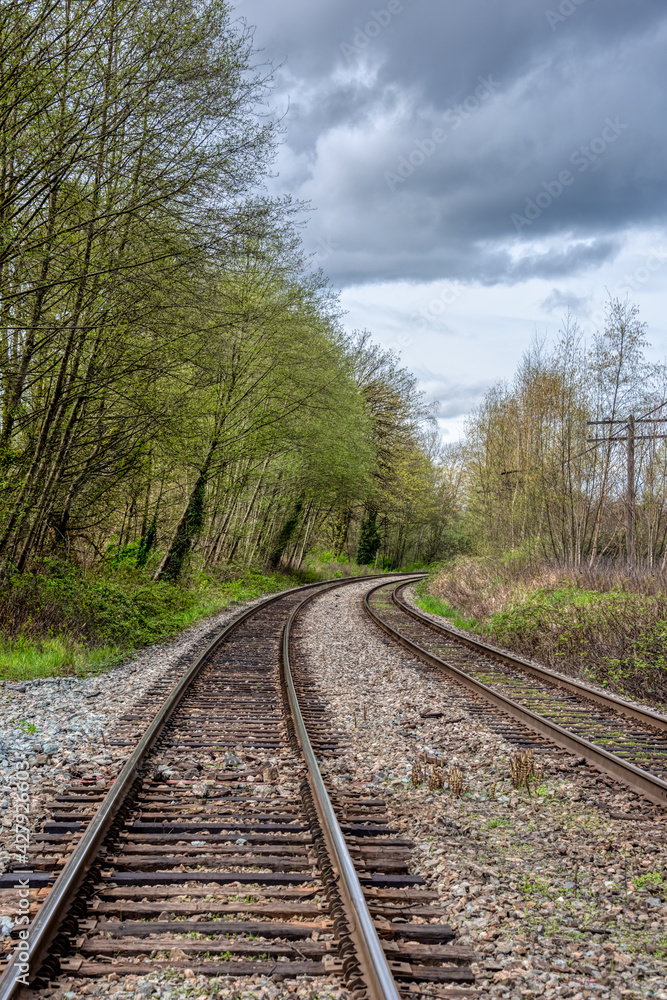 Curve of rail road pathways leading to a city Curve of rail road pathways leading to a city
