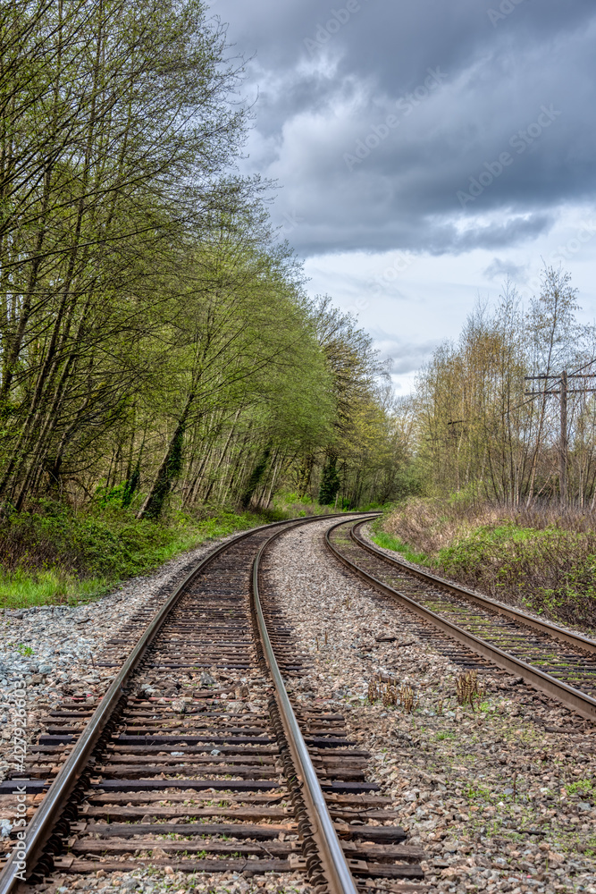 Curve of rail road pathways leading to a city