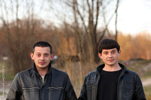 Two twin brothers portrait in nature