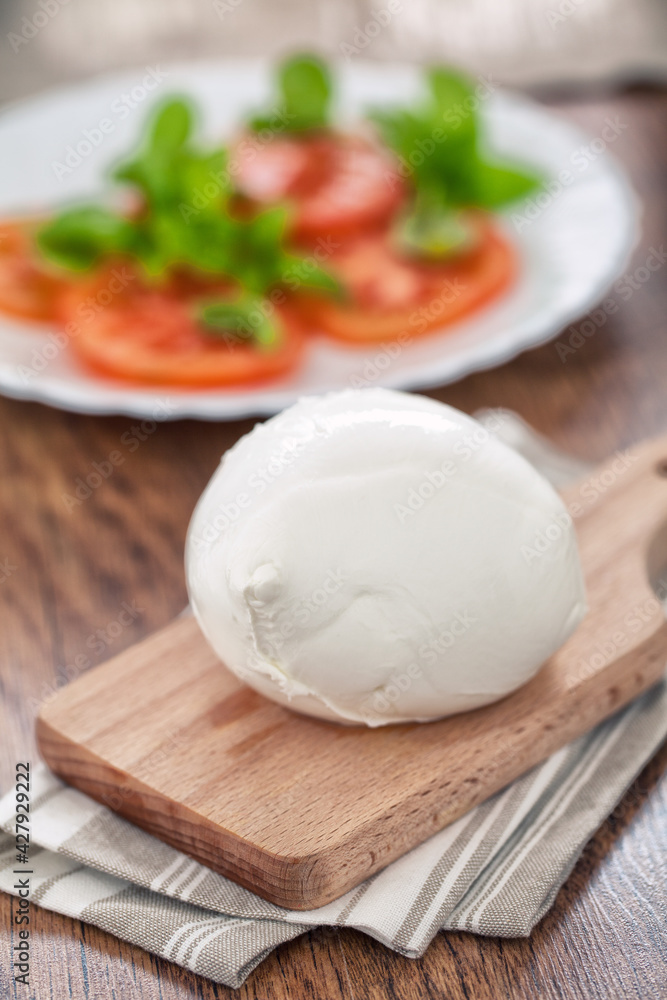 Buffalo Mozzarella, Italian cheese on wooden board. Buffalo Mozzarella, Italian cheese on wooden board.