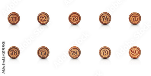 the numbers from seventy-one to eighty carved in round pieces of wood are isolated on a white background with shadow and reflection photo