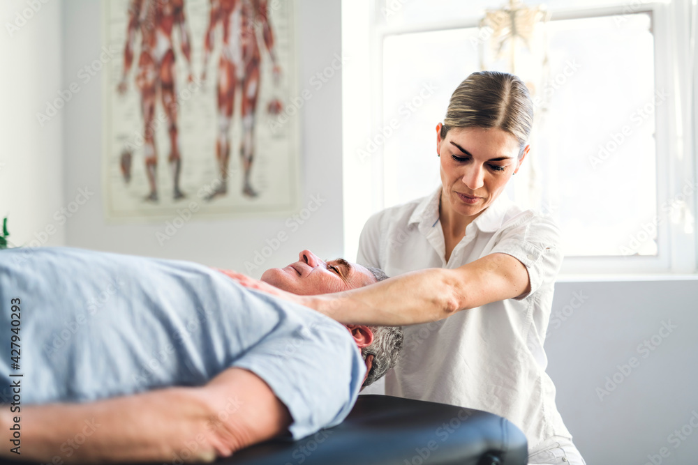 A Modern rehabilitation physiotherapy worker with senior client A Modern rehabilitation physiotherapy worker with senior client