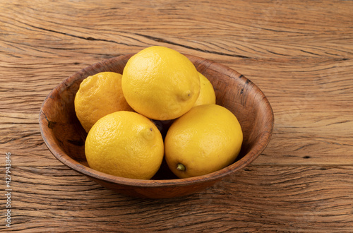 Sicilian lemons in a bowl over wooden table