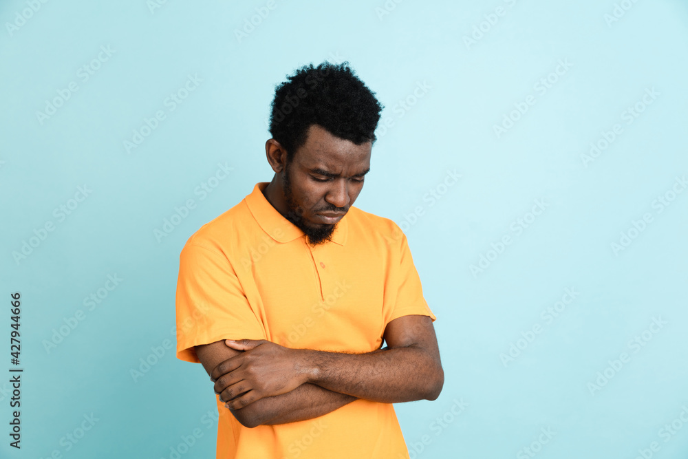 African man's portrait isolated over blue studio background with copyspace African man's portrait isolated over blue studio background with copyspace