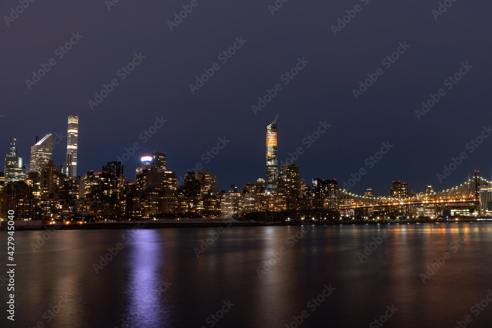Nighttime Midtown Manhattan Skyline with the Queensboro Bridge along the East River in New York City