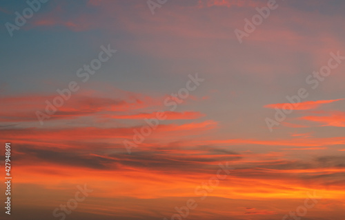 The sky at sunset at the sea beach in summer, The clouds are soft and fluffy floating on blue sky and pink and orange for backgrounds concept, Selective focus.