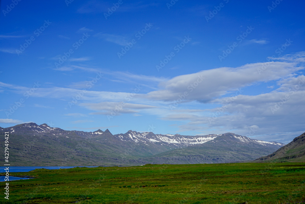 Image of a picnic under the wilderness with mountains, rivers and blue sky