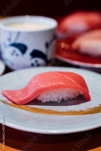 Sushi and Sashimi. Dishes of Sushi and Sashimi rolling on conveyer belt. photo