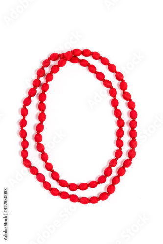 Vertical closeup of stylish upcycled red necklace made out of post-consumer waste, isolated on a white background. Creative reuse of waste, ideal gift for her.