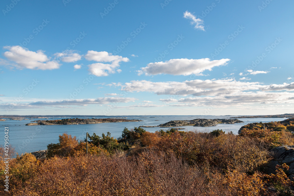 High-level view of the sea around islands of the Southern Gothenburg Archipelago, in Sweden, during a sunny day with blue sky and clouds. Archipelago of Gothenburg 