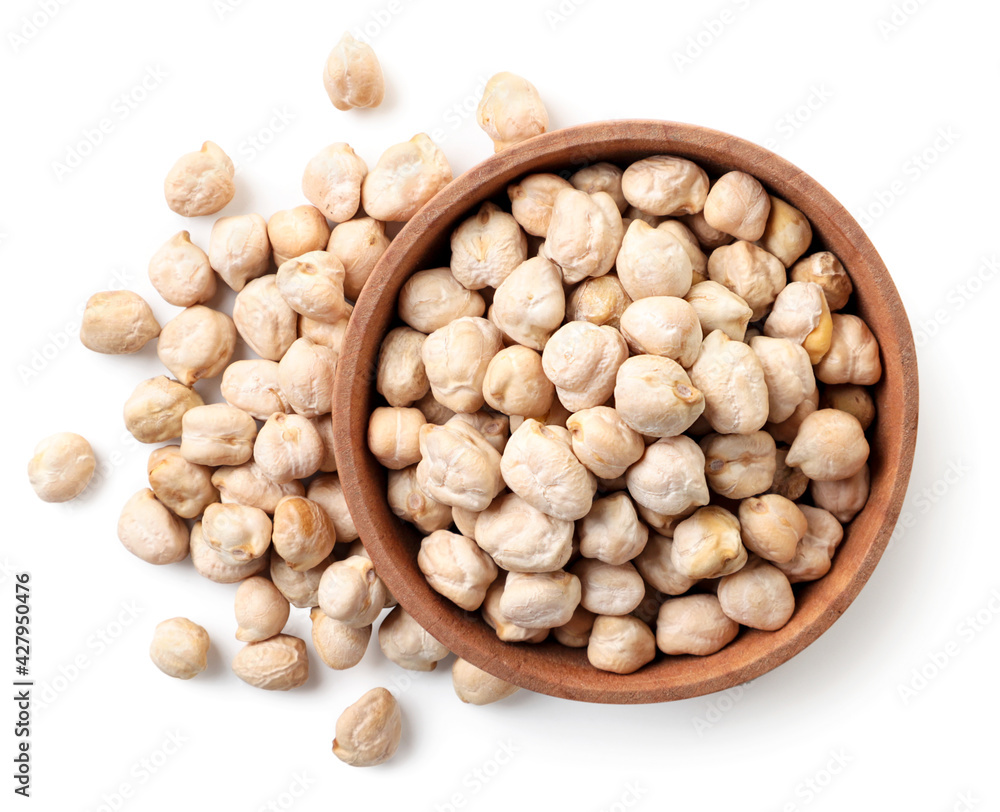 Dry chickpeas in a wooden plate on a white background, isolated. The view from top