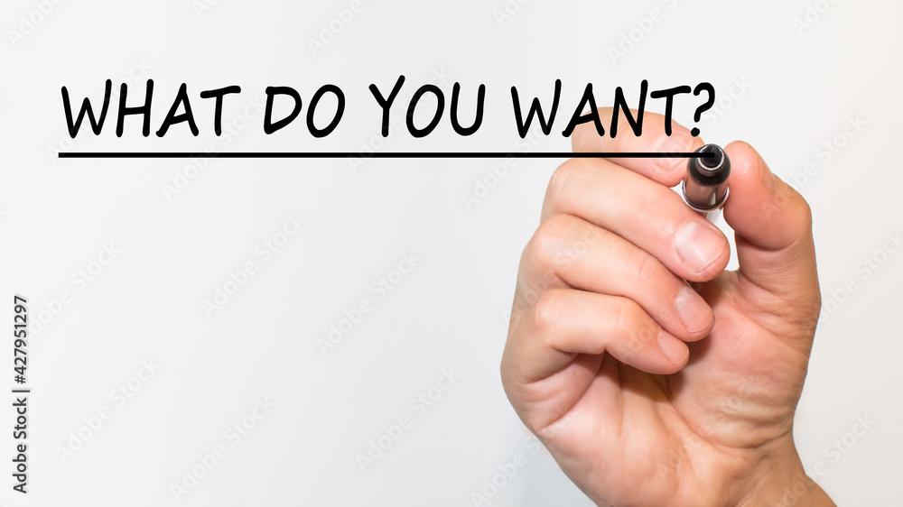the hand writes text WHAT DO YOU WANT with a marker on a white background. business concept the hand writes text WHAT DO YOU WANT with a marker on a white background. business concept
