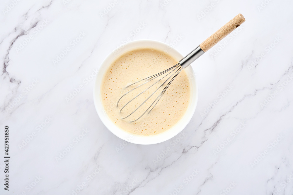Preparation of dough for home pancakes for Breakfast or for Maslenitsa. Ingredients on the table - wheat flour, eggs, butter, sugar, salt, milk. Recipe step by step. Top view with place for text. Preparation of dough for home pancakes for Breakfast or for Maslenitsa. Ingredients on the table - wheat flour, eggs, butter, sugar, salt, milk. Recipe step by step. Top view with place for text.