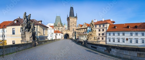 Amazing Sunny day on Charles bridge and historical center of Prague, buildings and landmarks of old town, Prague, Czech Republic Prague during quarantine restrictions. Spring or summer time.