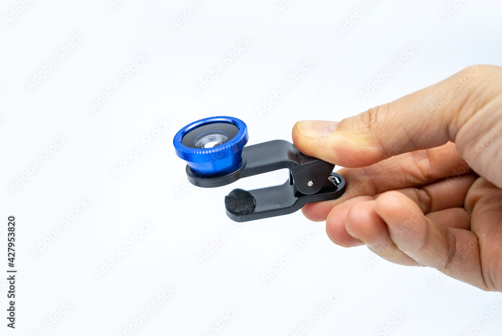 Phone photo lens with clips on white background. Extra macro camera for smartphone. Set of lenses wide angle, fish eye and macro Phone photo lens with clips on white background. Extra macro camera for smartphone. Set of lenses wide angle, fish eye and macro