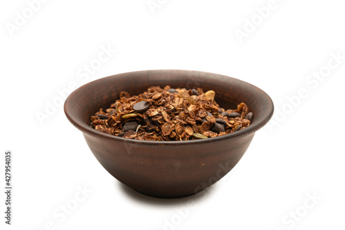 Chocolate granola cereal with nuts in a bowl background.