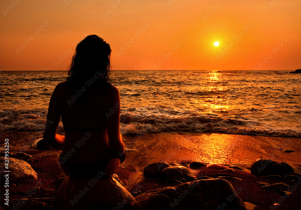 A lonely lady enjoying the sunset, at Lycodemus beach, Cythera (or 