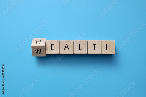 Wooden cubes with the words: health and wealth. Health is the main wealth photo