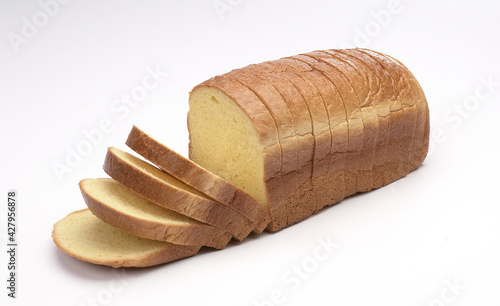loaf of bread cut into slices, isolated on white background 