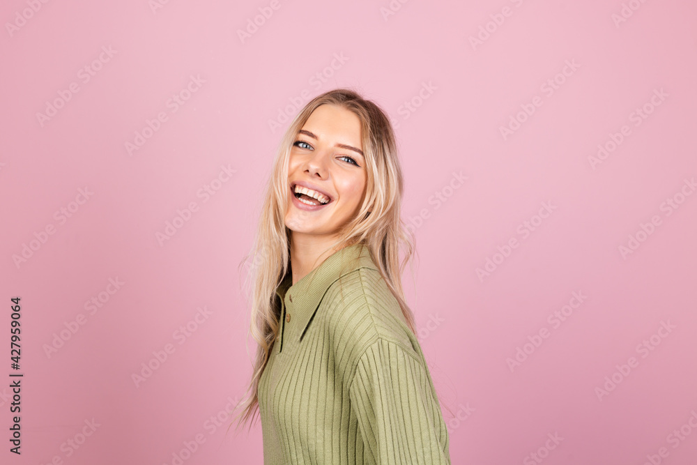 Pretty european woman in casual knitted sweater on pink background isolated looking to camera with a smile positive emotions Pretty european woman in casual knitted sweater on pink background isolated looking to camera with a smile positive emotions