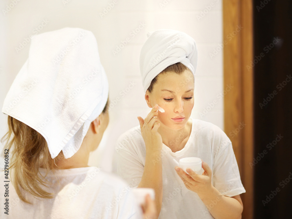 Magic anti-aging cream.Applying the cream. Magic anti-aging cream.Applying the cream.