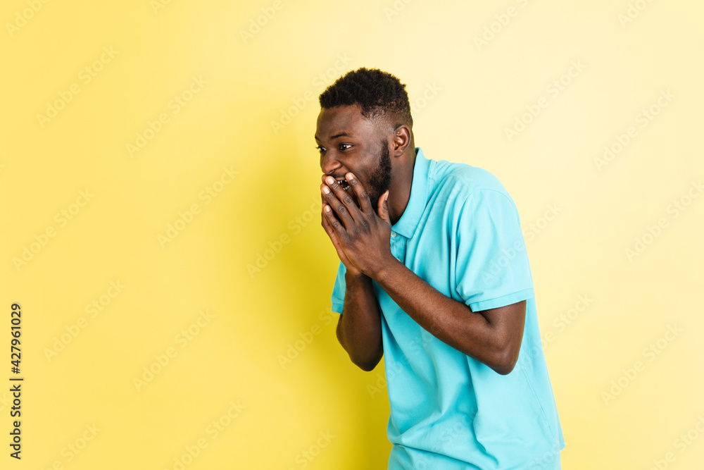 Portrait of young African man isolated over yellow studio background with copyspace. Portrait of young African man isolated over yellow studio background with copyspace.