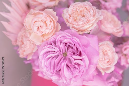 Light pink, purple, peach colour, white cute delicate small roses of different sizes, flowers in a lush bouquet. Macro