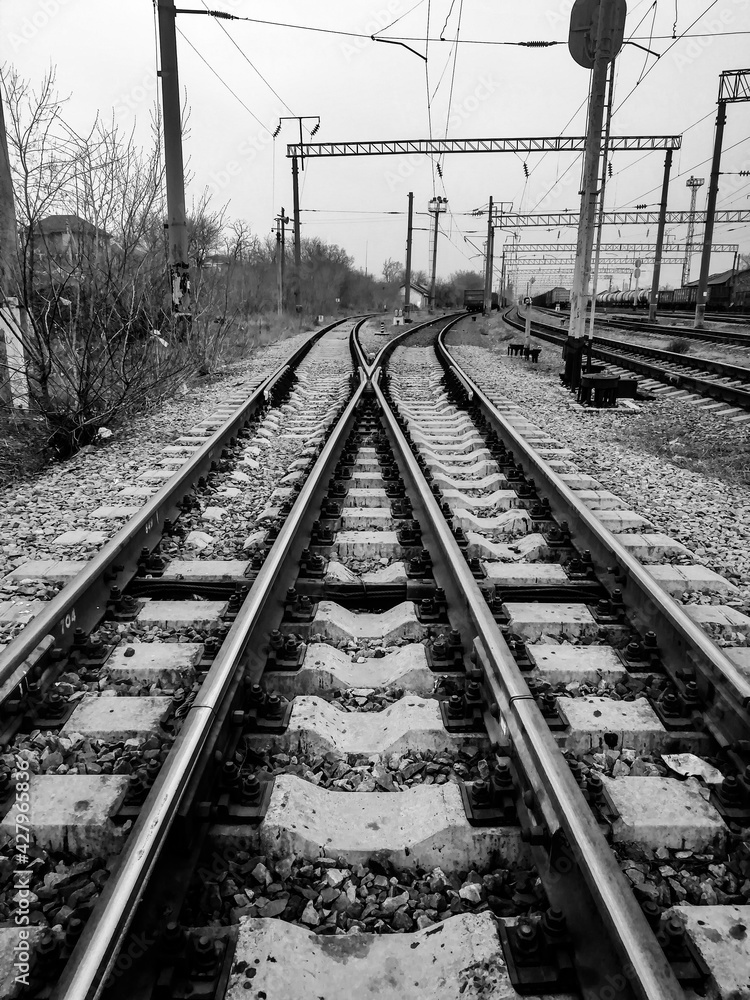 Monochrome railroad switches in cloudy weather in early spring.
