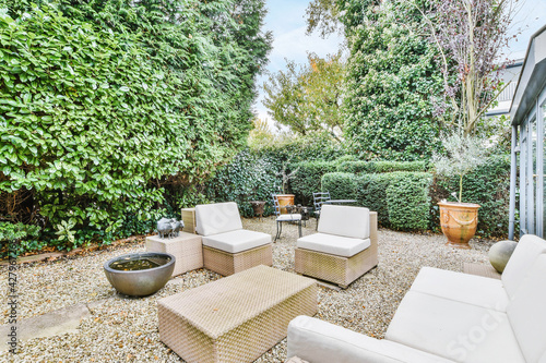 Beautiful backyard terrace full of furniture and decorative plants Fototapeta