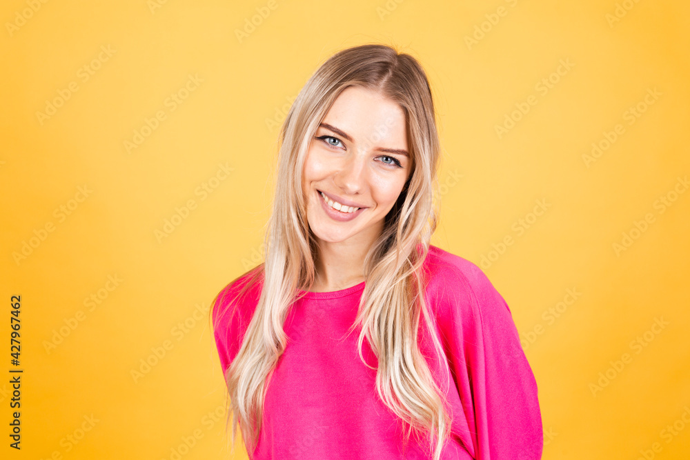 Pretty european woman in pink blouse on yellow background positive emotions smiling happy cheerful Pretty european woman in pink blouse on yellow background positive emotions smiling happy cheerful