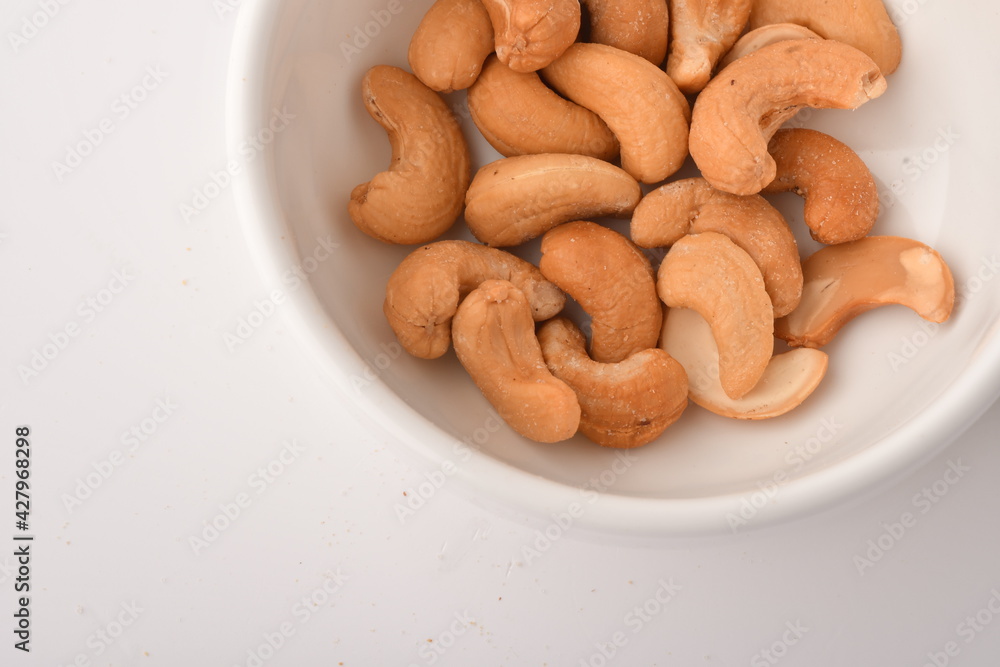 Fototapeta premium Heap of cashew nuts isolated on white background.