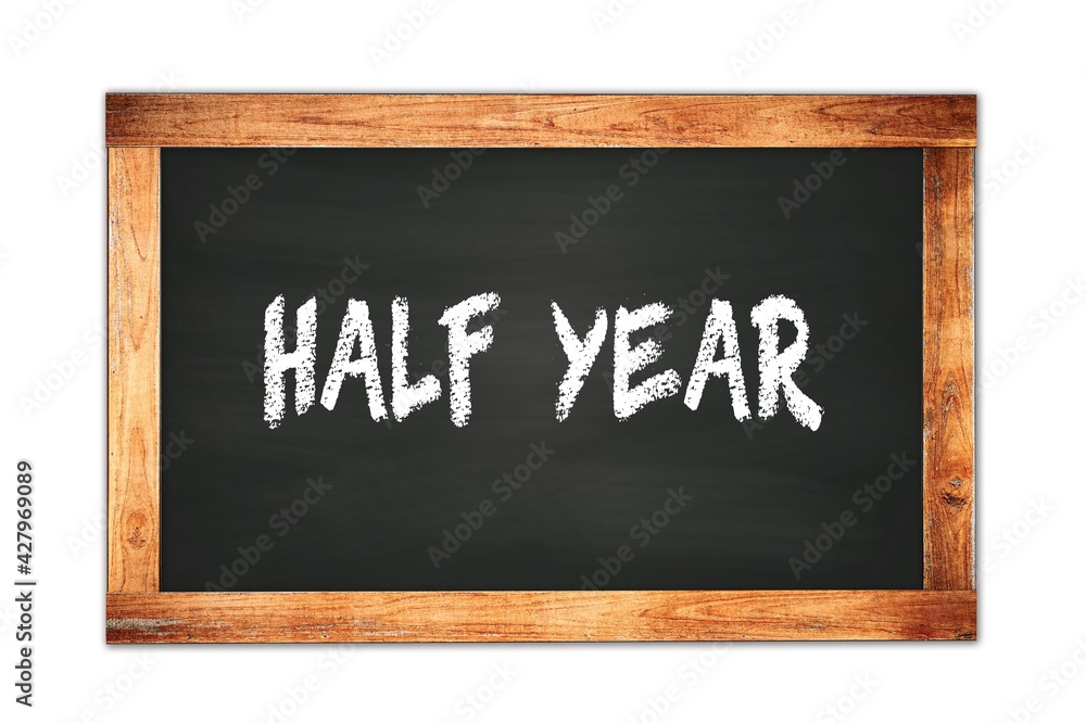 Fototapeta premium HALF YEAR text written on wooden frame school blackboard.