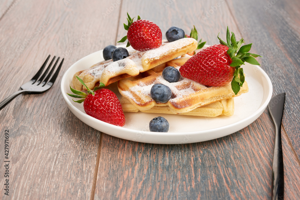 Belgian waffles with strawberries and blueberries. Belgian waffles with strawberries and blueberries.