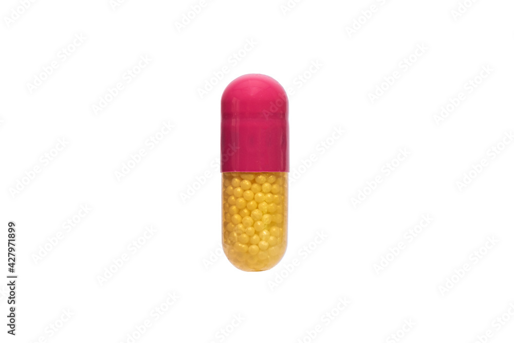 Close up yellow and pink medical pill or supplements in soft gel capsule Close up yellow and pink medical pill or supplements in soft gel capsule