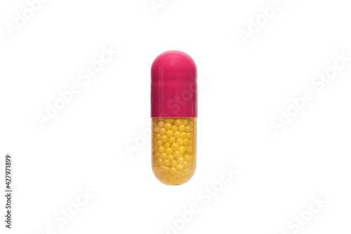 Close up yellow and pink medical pill or supplements in soft gel capsule