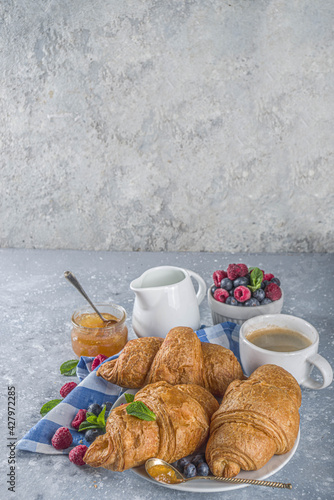 Sweet breakfast croissants with jam and berries