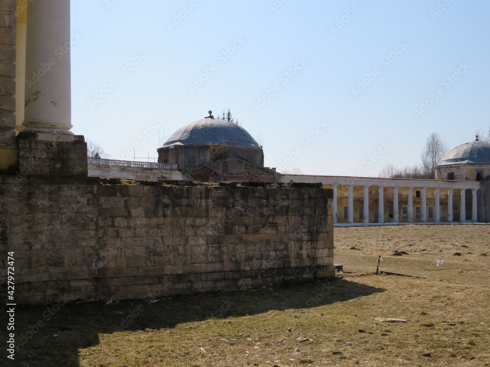 An old abandoned building with columns on a sunny day. An old abandoned building with columns on a sunny day.