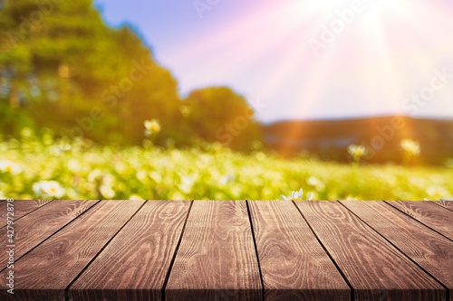 Dark wood table top with blur green nature background