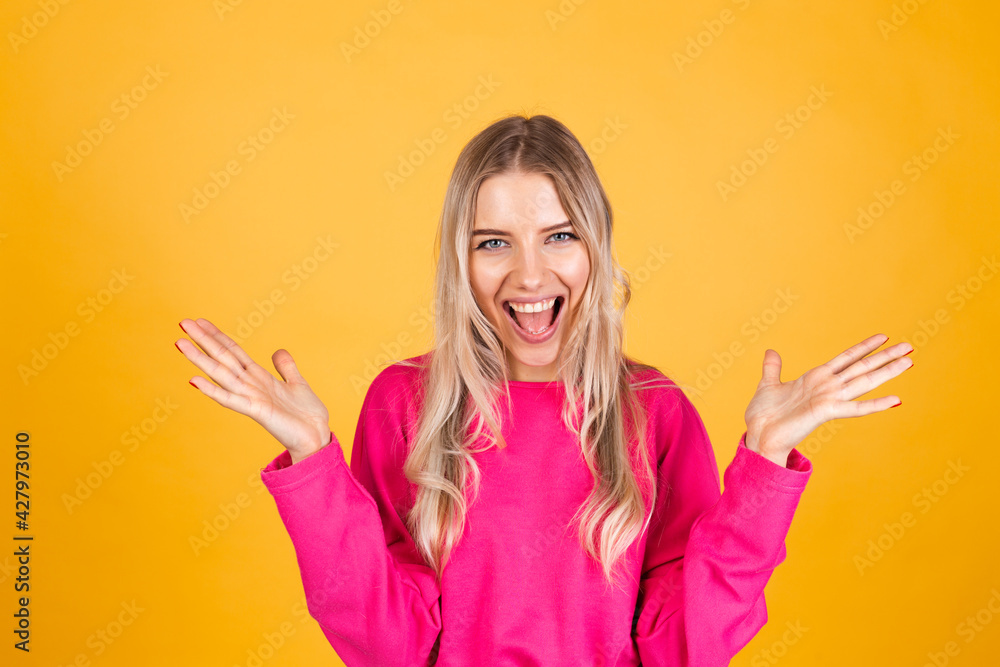 Pretty european woman in pink blouse on yellow background happy look to camera shocked amazed surprised open mouth Pretty european woman in pink blouse on yellow background happy look to camera shocked amazed surprised open mouth