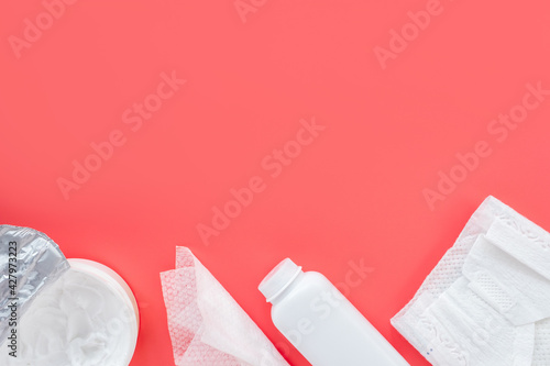 Baby care cosmetics on a pink background, flat flat, top view, copy space for text, mockup. Trendy background, hygiene of newborn girls