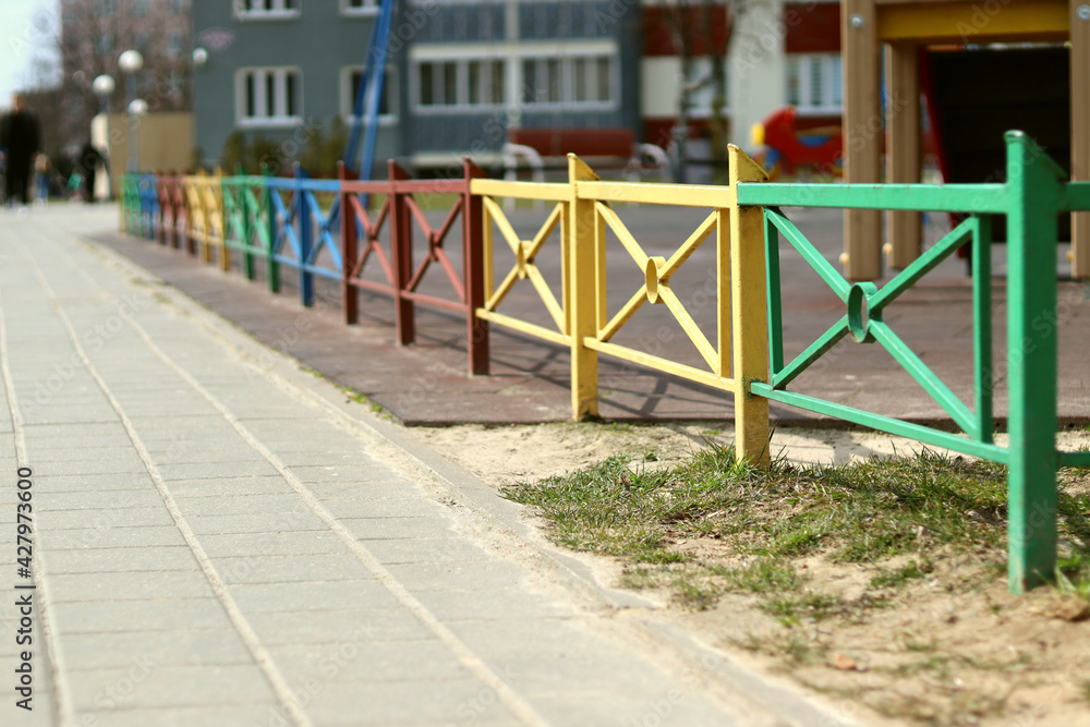 Fototapeta premium Colorful fence and playground with blurred background