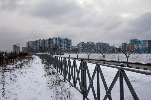 Urban new buildings next to the highway in winter © Elena
